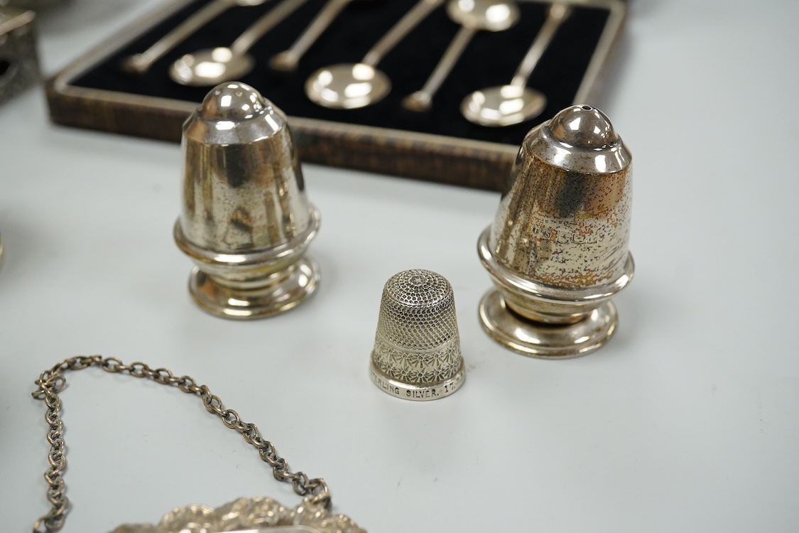A collection silver and white metal to include a cased set of six George V seal top coffee spoons, Birmingham, 1927, a pair of Scottish napkin rings embossed with thistles, a pair of embossed heart shaped bonbon dishes,